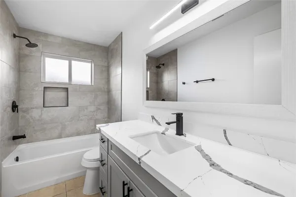 a bathroom with a sink a toilet and bathtub