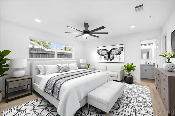 a bedroom with a bed and ceiling fan