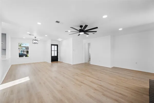 a view of an empty room with a ceiling fan