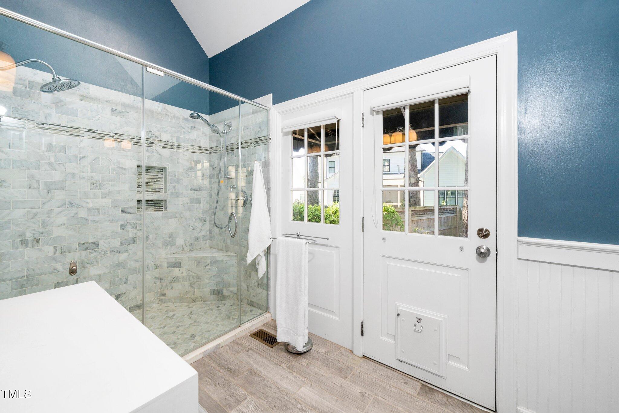 1712 Briarforest Place Raleigh, NC 27615 - Photo 23 of 55 Owners have a door in the bathroom, allowing muddy dogs to be brought directly in the house without dragging muddy paws through the house. The dog door provides easy access to the backyard.
