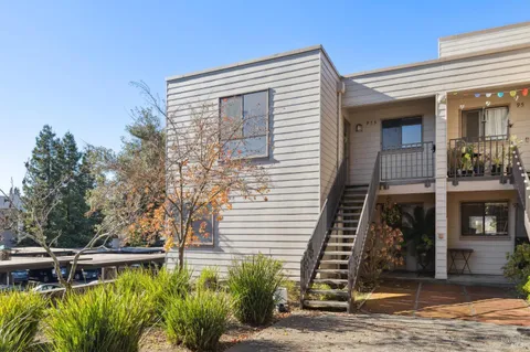 a view of a chairs and table in the balcony