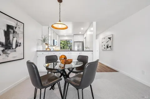 a living room with furniture a fireplace and a large window