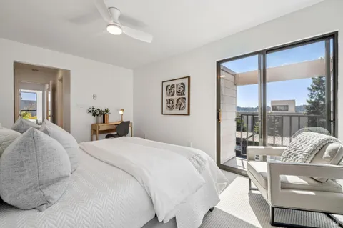 a bed room with a bed and a large window