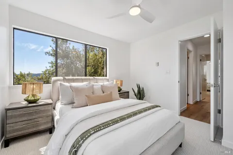 an aerial view of a house with a yard and large tree