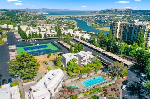 a front view of multi story building with retail shops