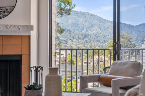 a living room with furniture and a floor to ceiling window