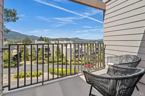 a view of a balcony with furniture