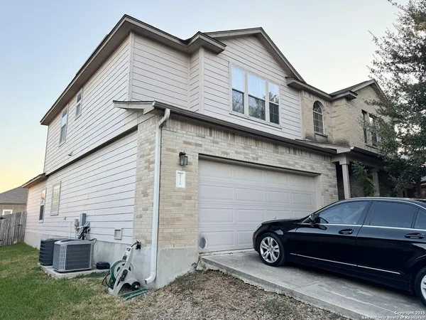 a car parked in front of white house
