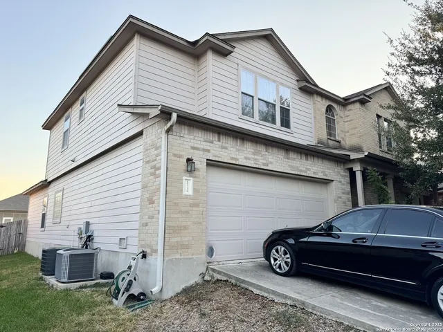 a car parked in front of white house