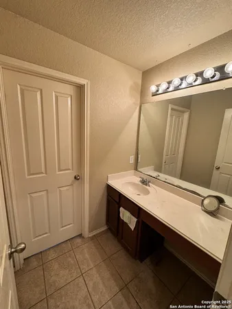a bathroom with a sink double vanity and a mirror