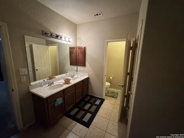 a bathroom with a sink toilet and mirror