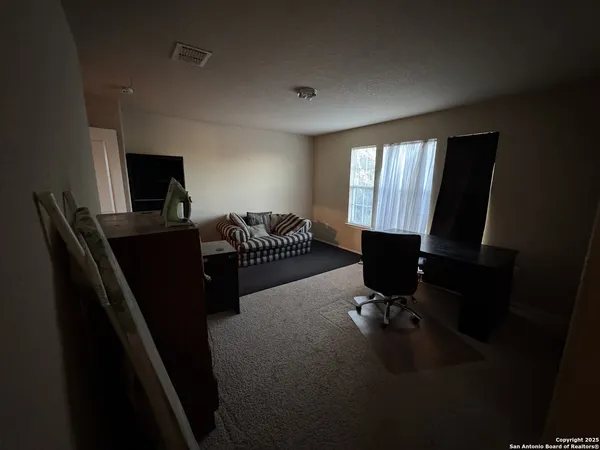 a living room with furniture rug and a window