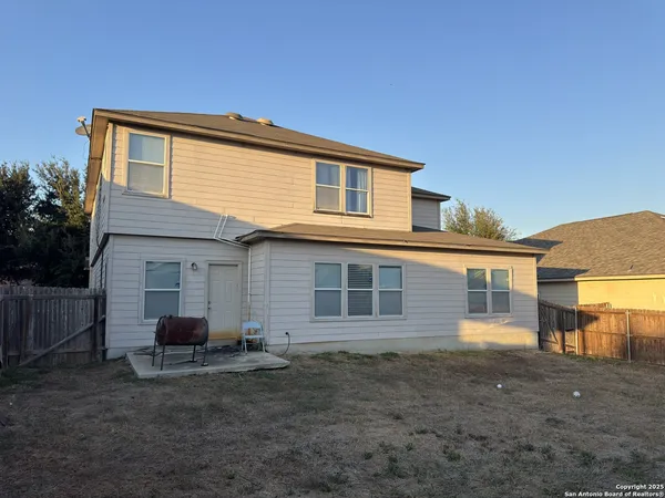 a view of a house with a backyard