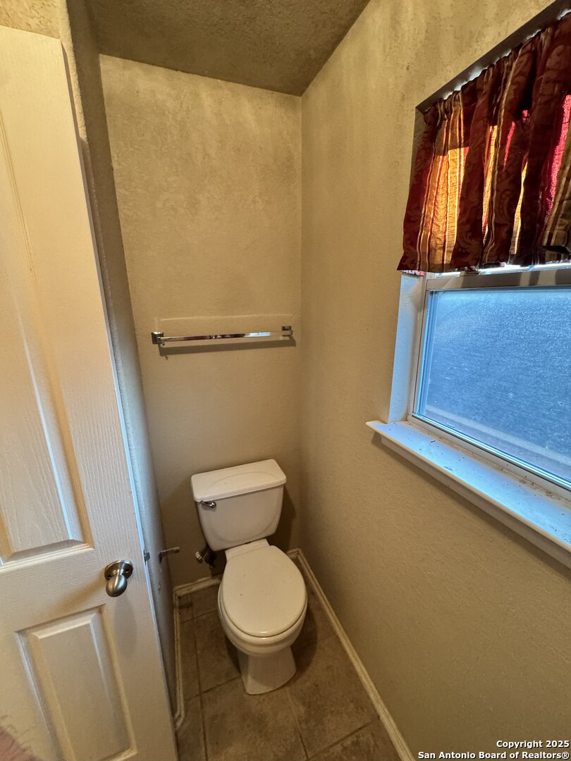6714 Harbor Fields Converse, TX 78109 - Photo 9 of 29 a bathroom with a toilet and a shower
