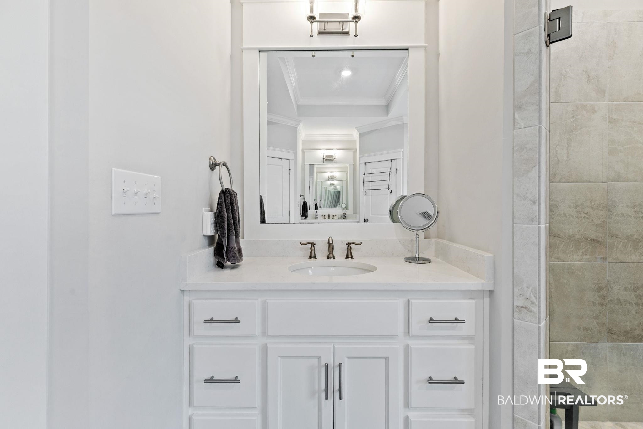13233 Ibis Boulevard Daphne, AL 36527 - Photo 35 of 100 Bathroom vanity featuring a white cabinetry, light-toned countertop, integrated sink, and modern faucet