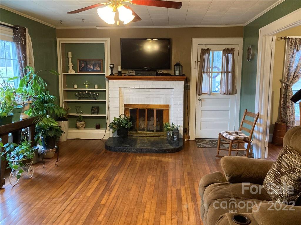 135 Allen Street Rutherfordton, NC 28139 - Photo 5 of 10 a living room with furniture a flat screen tv and a fireplace