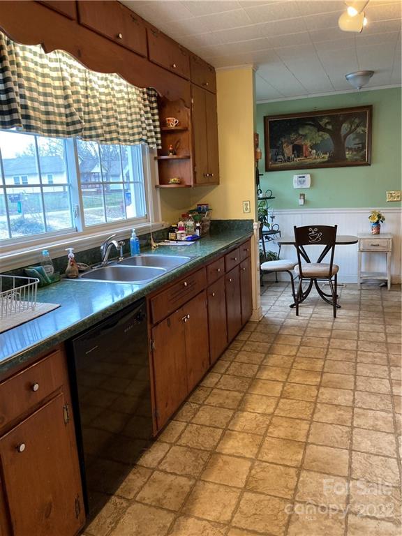 135 Allen Street Rutherfordton, NC 28139 - Photo 8 of 10 a kitchen with stainless steel appliances wooden cabinets a sink and a stove