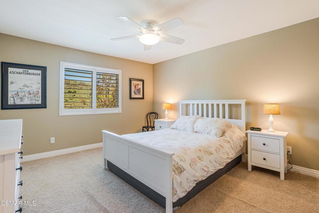 764 Coldbrook Place Simi Valley, CA 93065 - Photo 33 of 56 a bedroom with a bed and a chandelier