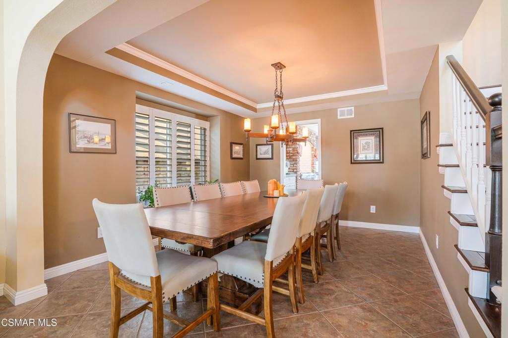 764 Coldbrook Place Simi Valley, CA 93065 - Photo 9 of 56 a dining room with furniture a chandelier and wooden floor