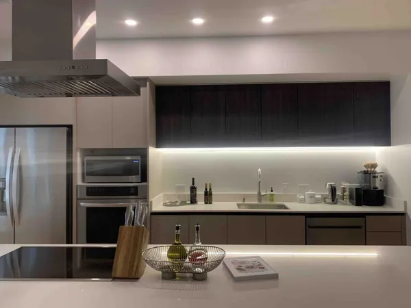 a kitchen with kitchen island a counter space and stainless steel appliances
