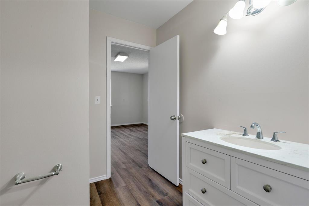 209 Mistletoe Lane Keene, TX 76059 - Photo 27 of 38 a bathroom with a sink mirror and vanity