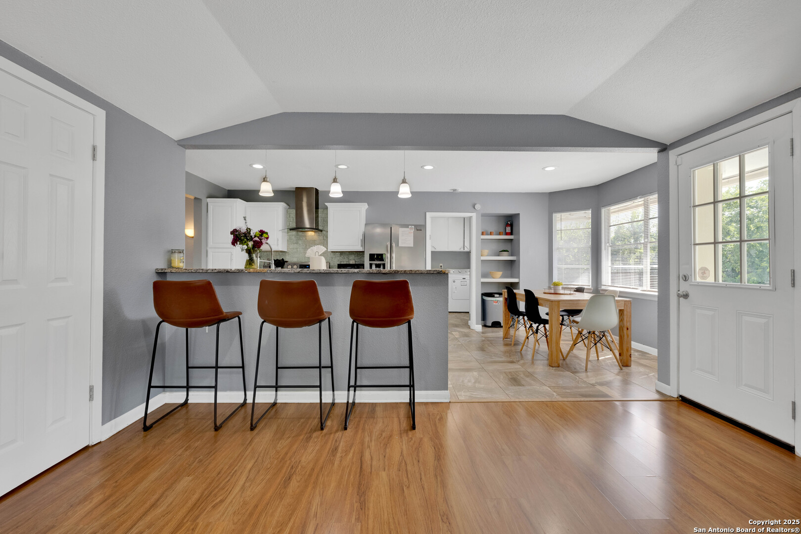 103 Shalimar Drive Castle Hills, TX 78213 - Photo 16 of 56 a kitchen with stainless steel appliances kitchen island a table and chairs in it