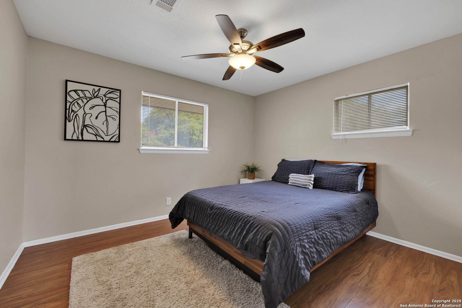 103 Shalimar Drive Castle Hills, TX 78213 - Photo 38 of 56 a bedroom with a bed and a painting on the wall