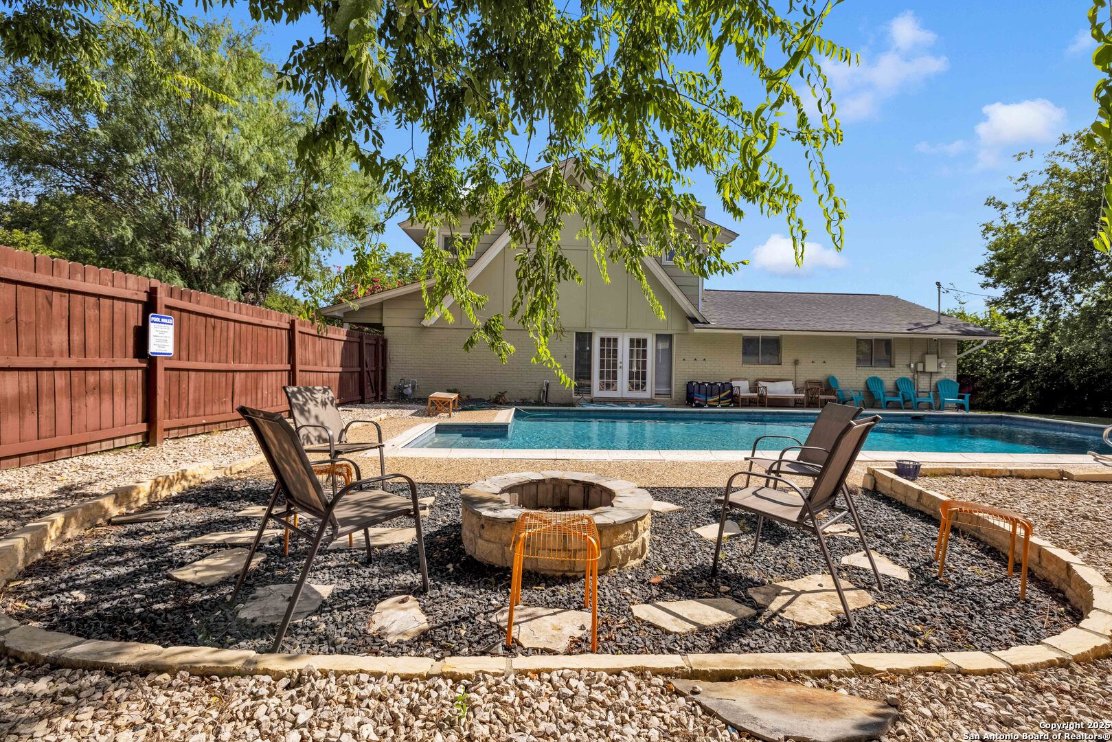 103 Shalimar Drive Castle Hills, TX 78213 - Photo 52 of 56 a roof deck with table and chairs under an umbrella