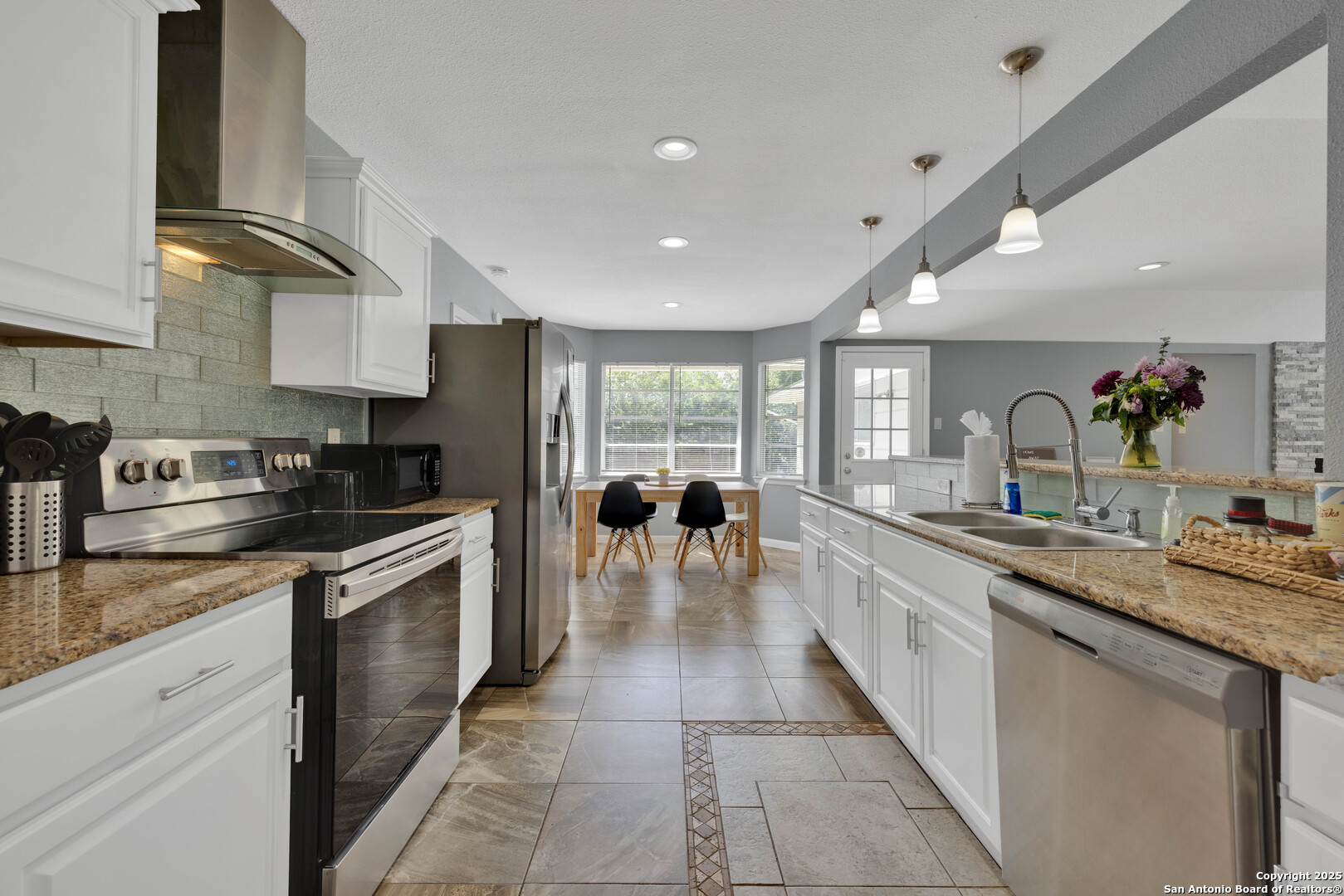 103 Shalimar Drive Castle Hills, TX 78213 - Photo 7 of 56 a large kitchen with stainless steel appliances granite countertop a large counter top a stove a chimney a sink and a refrigerator
