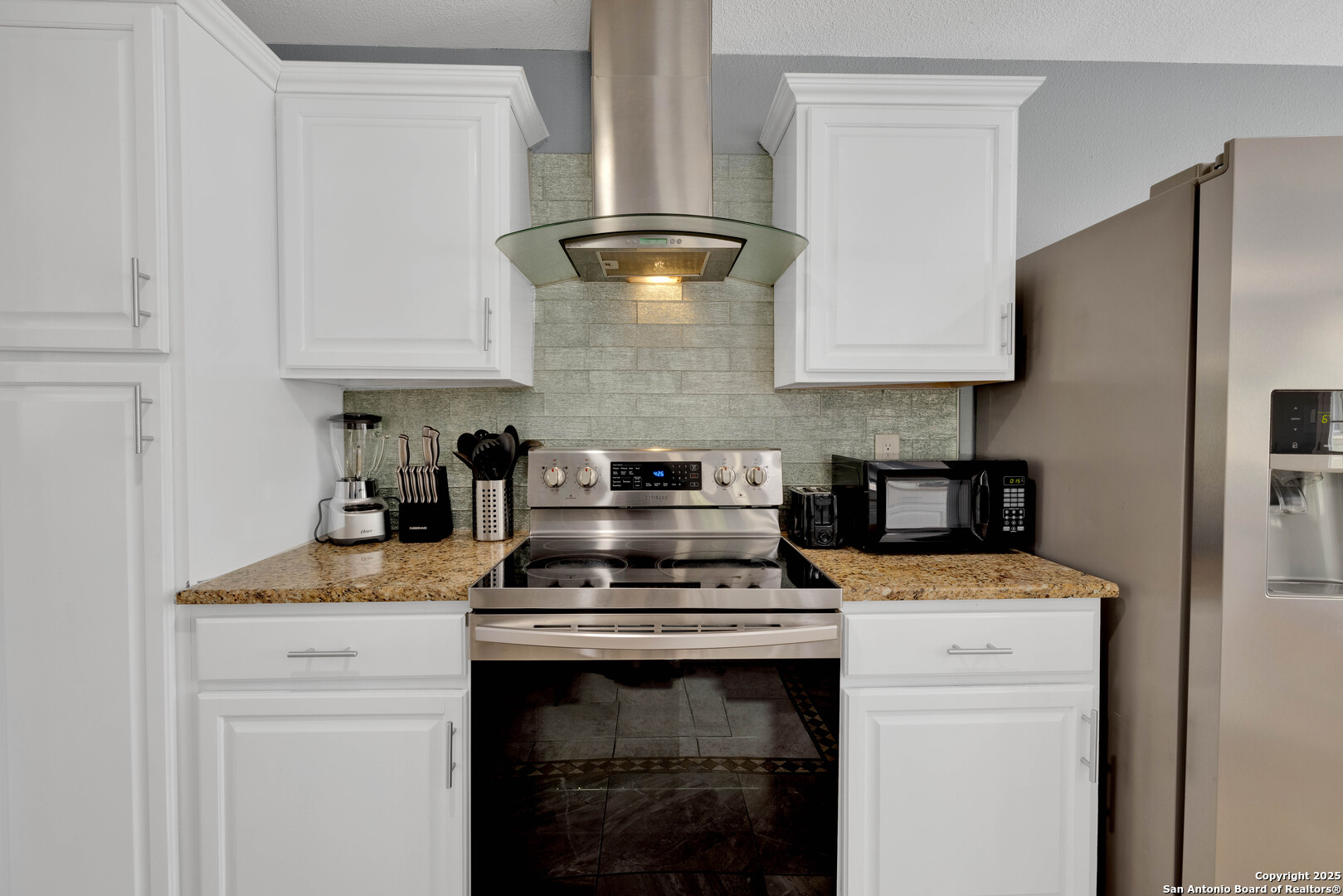 103 Shalimar Drive Castle Hills, TX 78213 - Photo 8 of 56 a kitchen with a stove and a refrigerator