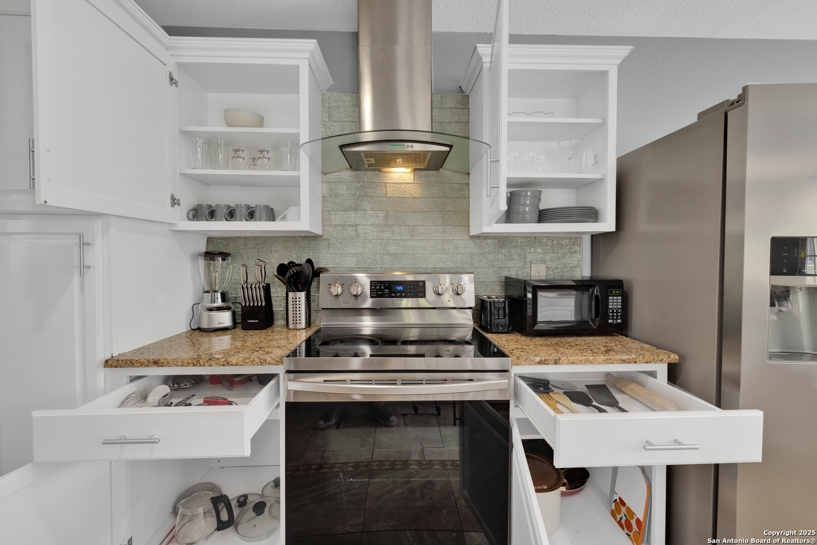 103 Shalimar Drive Castle Hills, TX 78213 - Photo 9 of 56 a kitchen with a stove and a refrigerator