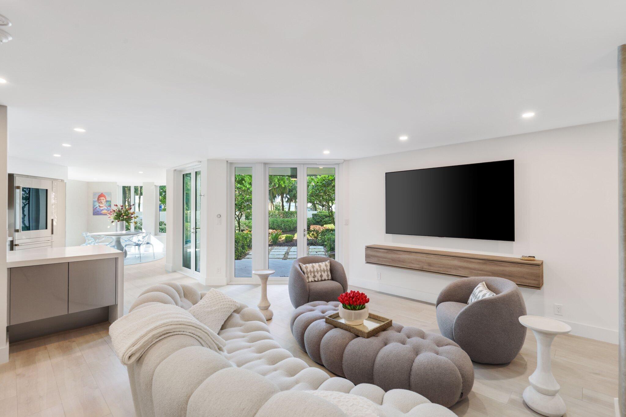 100 Southeast 5th Avenue, Unit 106 Boca Raton, FL 33432 - Photo 8 of 81 a living room with furniture and a flat screen tv