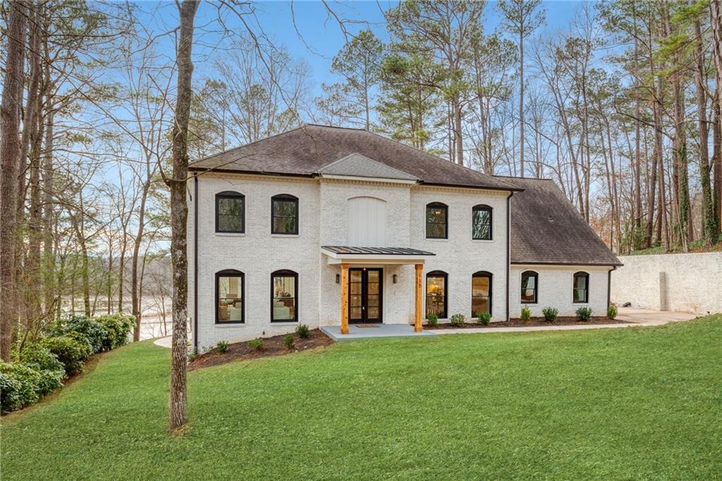 115 Ridgemont Trace Northeast Sandy Springs, GA 30350 - Photo 1 of 1 a front view of a house with a yard