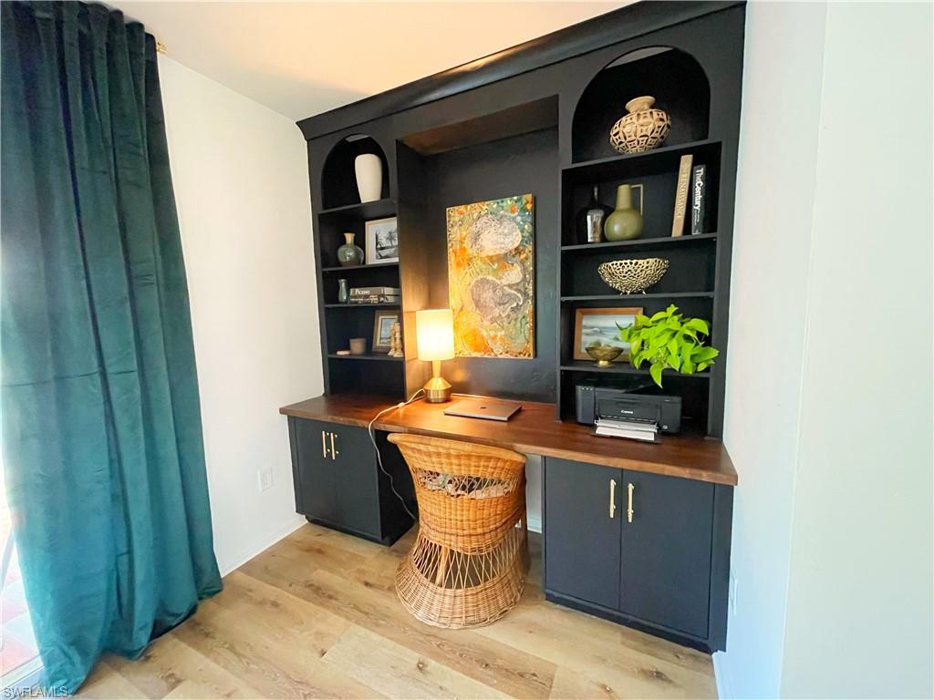 4811 Gary Road Bonita Springs, FL 34134 - Photo 18 of 35 Office space with built in shelves, light wood-type flooring, and built in desk