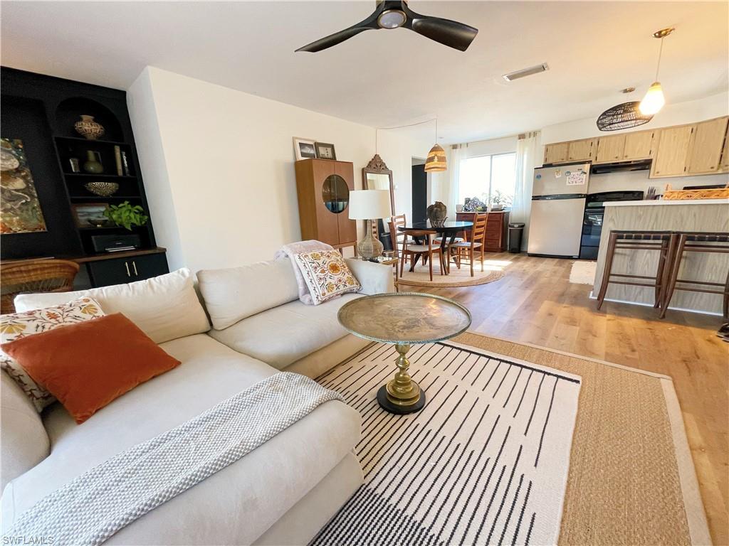 4811 Gary Road Bonita Springs, FL 34134 - Photo 21 of 35 Living area featuring light wood finished floors, built in features, and a ceiling fan