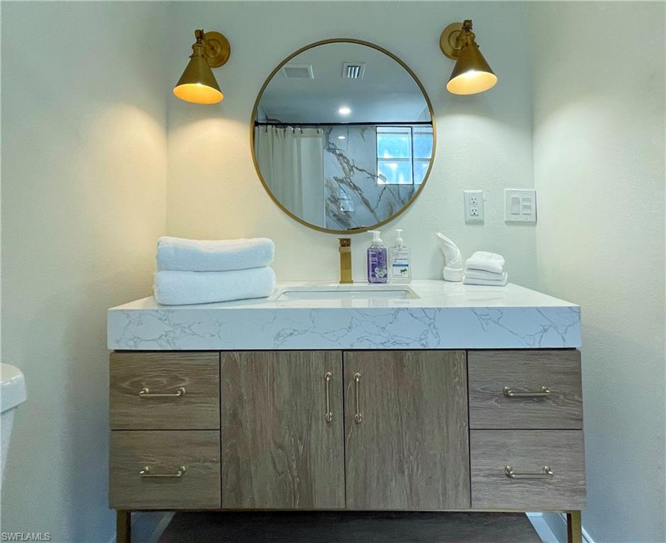 4811 Gary Road Bonita Springs, FL 34134 - Photo 24 of 35 Bathroom with vanity, curtained shower, and a textured wall
