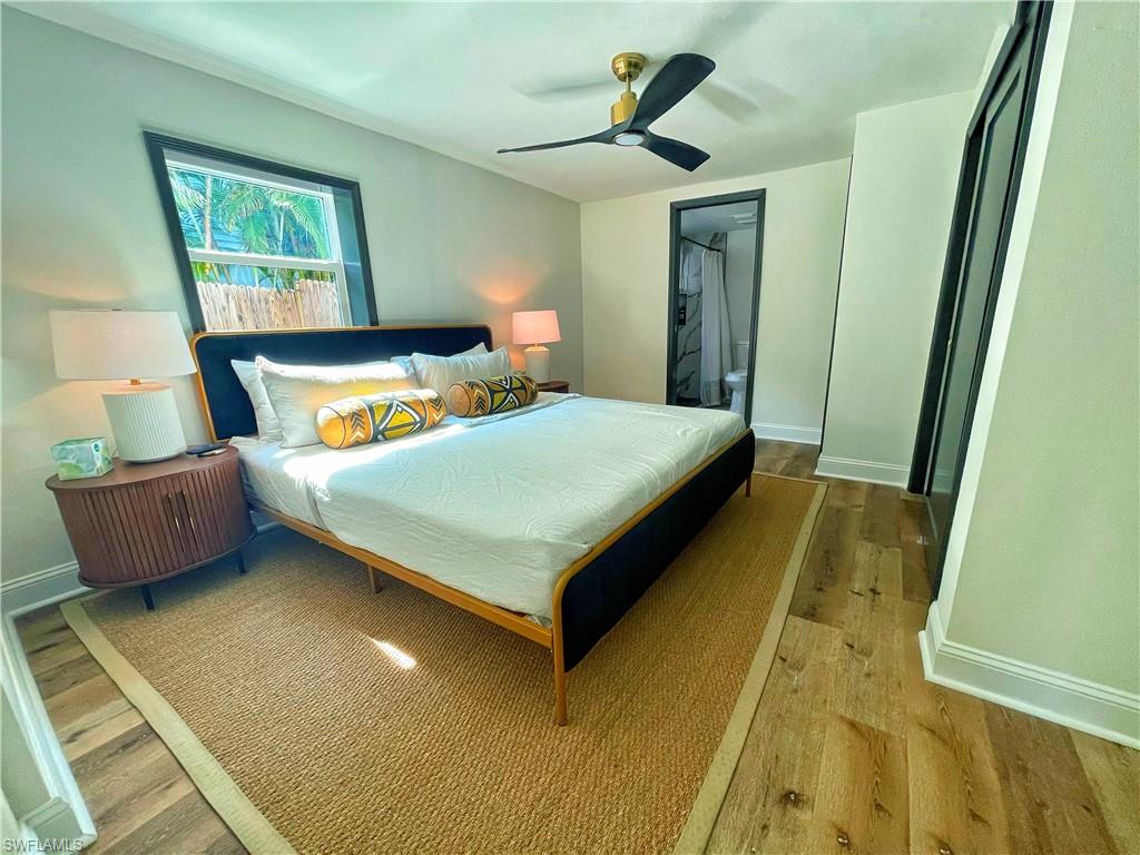 4811 Gary Road Bonita Springs, FL 34134 - Photo 25 of 35 Bedroom with wood finished floors, ensuite bath, and ceiling fan