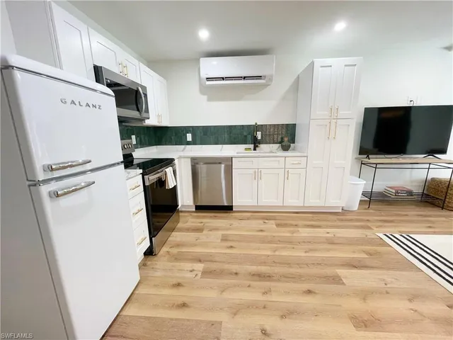 a kitchen with a stove and a microwave