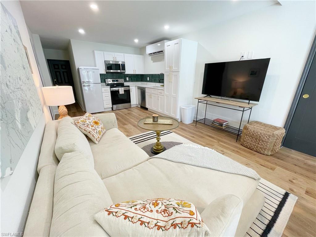 4811 Gary Road Bonita Springs, FL 34134 - Photo 29 of 35 Living area with light wood-type flooring, recessed lighting, and an AC wall unit