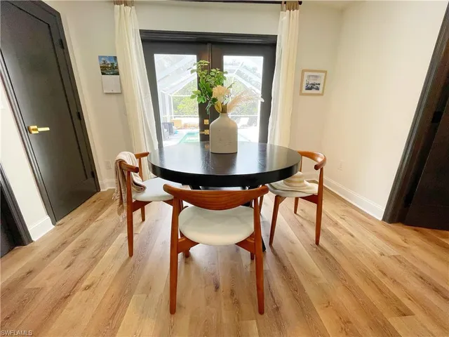 a living room with a bed and flat screen tv