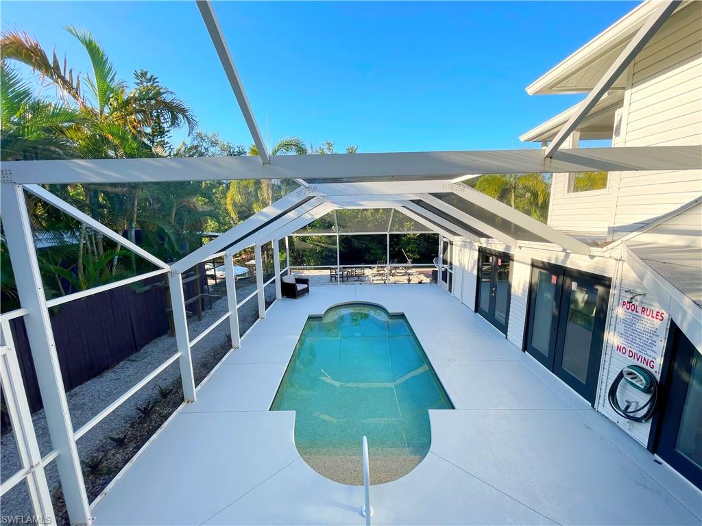 4811 Gary Road Bonita Springs, FL 34134 - Photo 5 of 35 Outdoor pool with a patio area, glass enclosure, and a sunroom