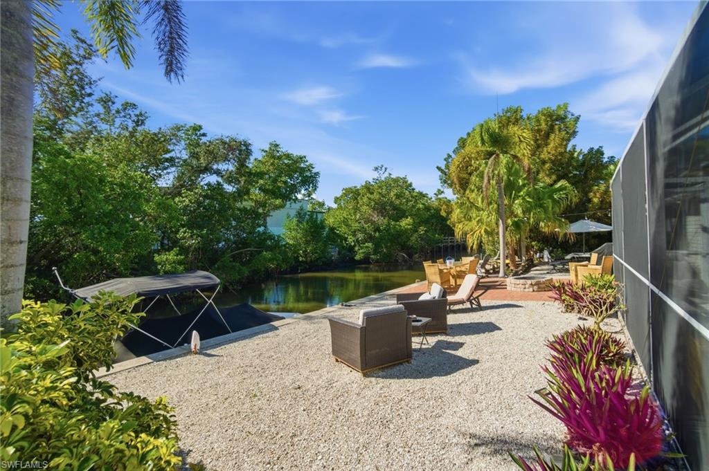 4811 Gary Road Bonita Springs, FL 34134 - Photo 7 of 35 View of patio / terrace with a lanai, a water view, a boat dock, and a sunroom