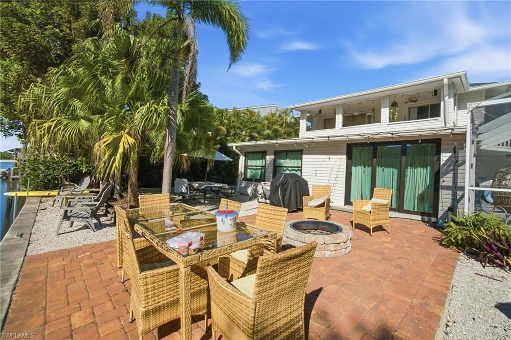 4811 Gary Road Bonita Springs, FL 34134 - Photo 8 of 35 View of patio / terrace featuring an outdoor fire pit, grilling area, and outdoor dining space