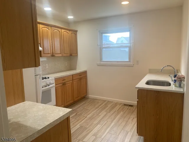 a kitchen with a sink a stove and cabinets