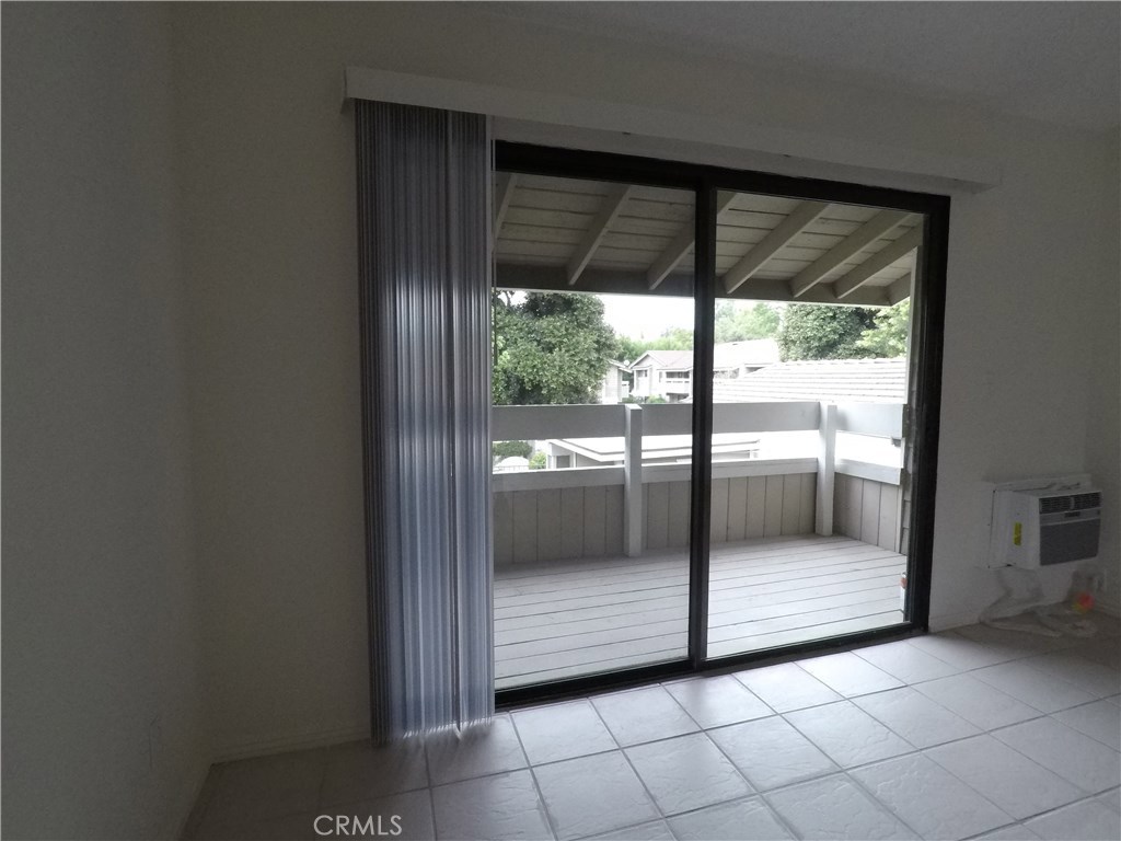 230 Springview Irvine, CA 92620 - Photo 16 of 30 a view of a glass door and a yard from a corridor