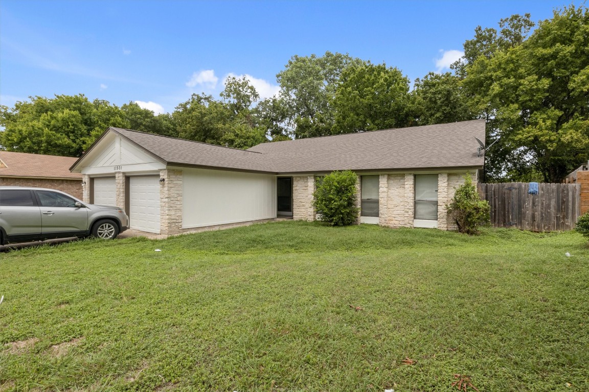 11501 Walnut Ridge Drive, Unit B Austin, TX 78753 - Photo 1 of 1 a view of a yard in front of a house with plants and large tree
