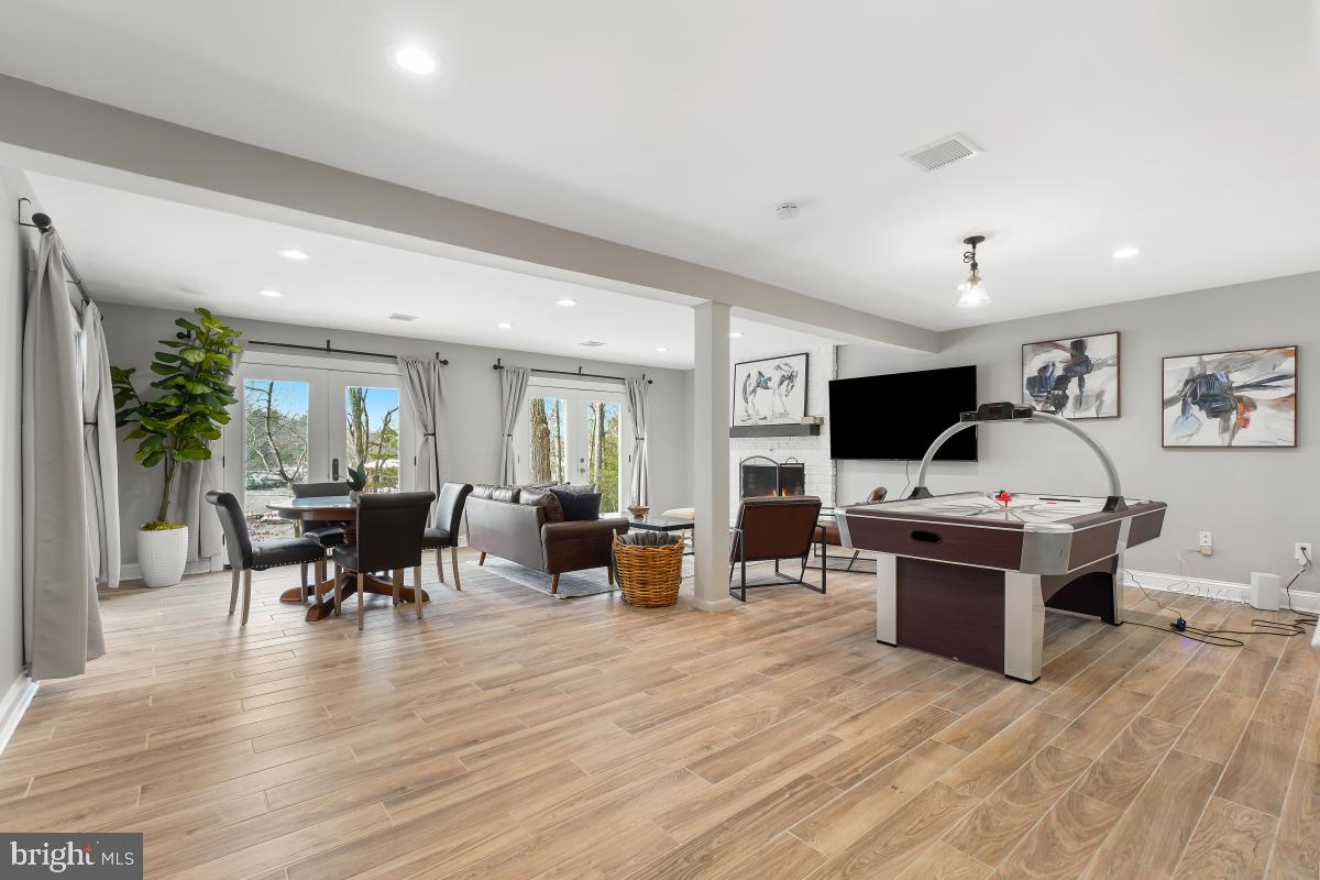 1820 Woods Road Annapolis, MD 21401 - Photo 30 of 51 LL rec room w/walk out to patio and pier.