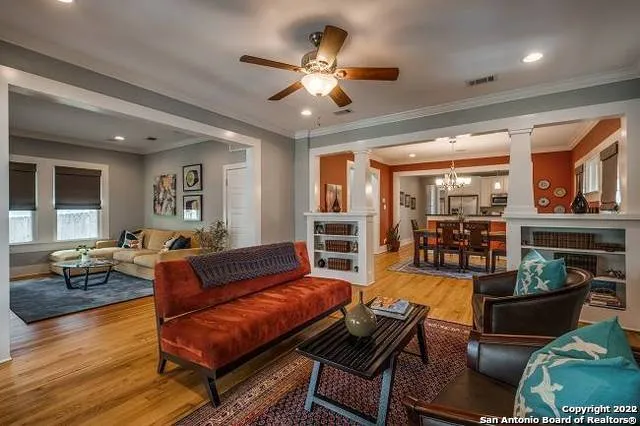 a living room with furniture and wooden floor