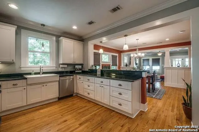 a kitchen with granite countertop white cabinets and white appliances