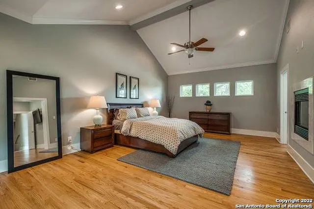 a spacious bedroom with a large bed and a chandelier